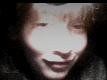 a close up of a woman 's face with a light shining on her face