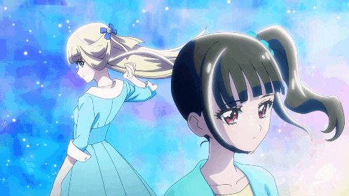 a girl in a blue dress is standing next to another girl with a ponytail