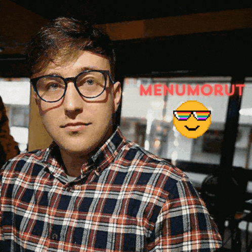 a man wearing glasses and a plaid shirt with menumorut written in red