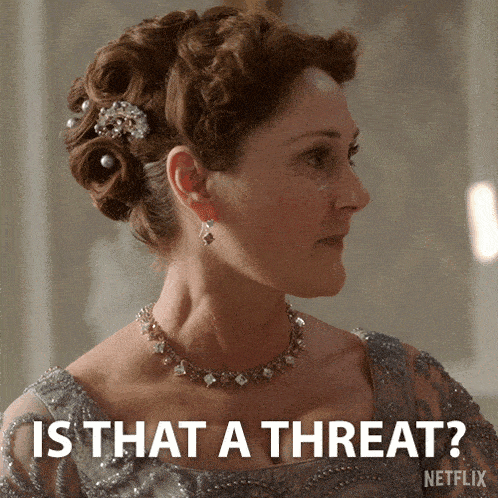 a woman is wearing a necklace and earrings and says is that a threat
