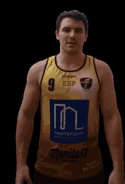 a man wearing a yellow jersey with the number 9 on the front