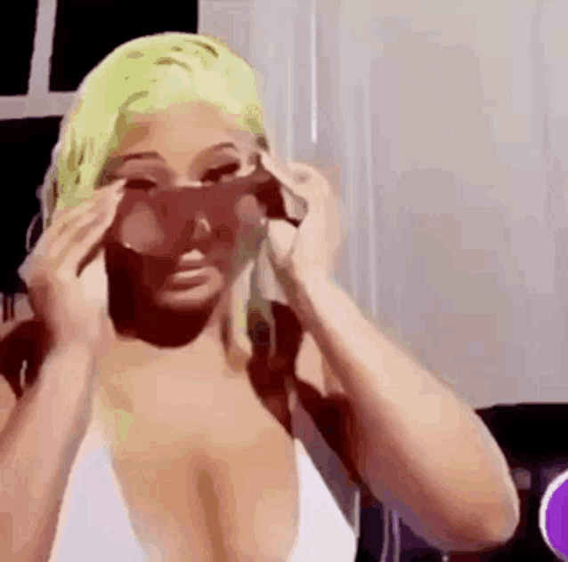 a woman is wearing sunglasses and a white bikini top .