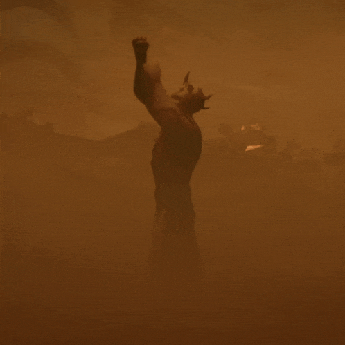 a statue of a man with horns is upside down in a foggy area