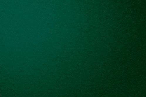 a close up of a dark green background with a gradient in the middle .