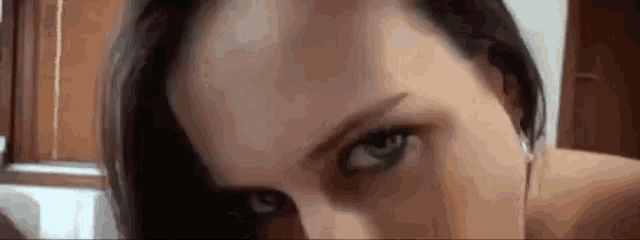 a close up of a woman 's face with her eyes closed and a man giving her a blowjob .
