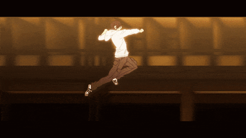 a man in a white shirt and black pants jumps in the air