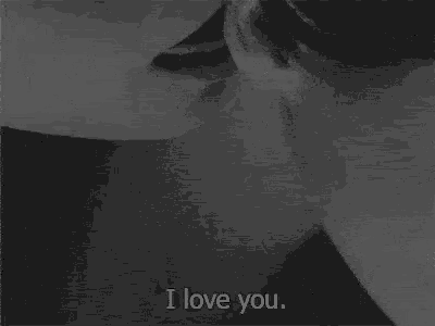 a black and white photo of a man and woman kissing with the words i love you
