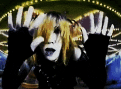 a woman with long blonde hair is making a peace sign