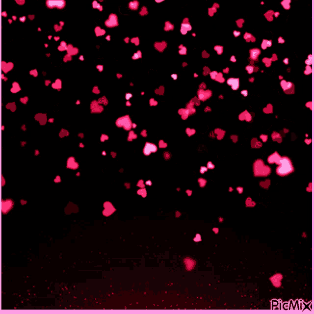 pink hearts are falling on a black background with picmix in the corner