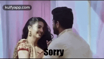 a man and a woman are standing next to each other and the woman is saying `` sorry '' .