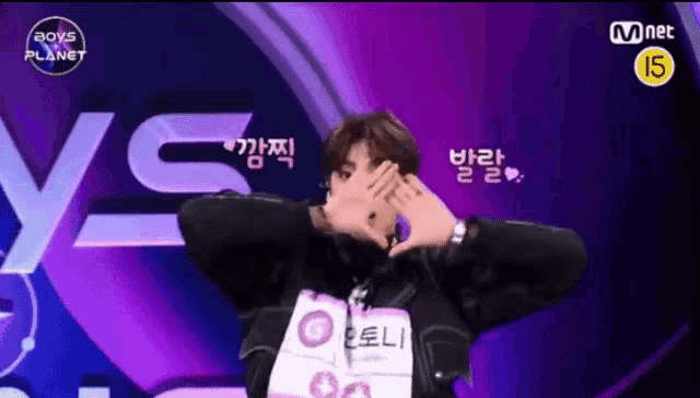 a man covering his face with his hands in front of a boys planet logo