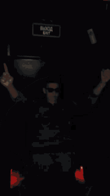 a blurry picture of a boy wearing sunglasses and a hoodie