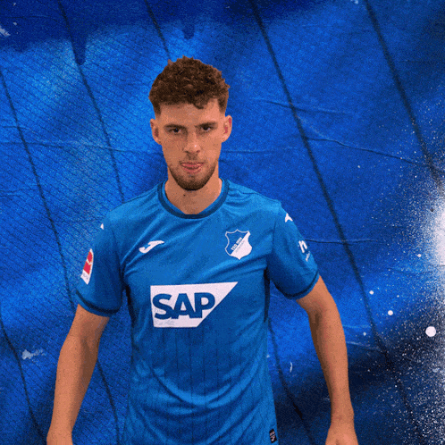 a man wearing a blue shirt with the word sap on the front