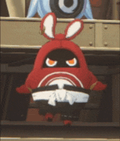 a red cartoon character with bunny ears and a karate belt