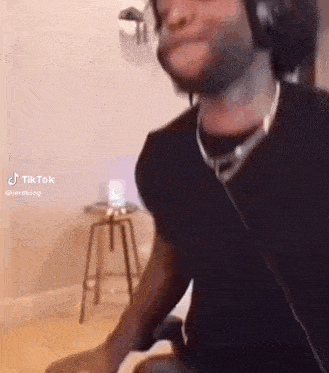 a man wearing headphones is sitting in a chair in a room .