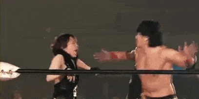 two men are wrestling in a ring and one of them is knocking the other out .
