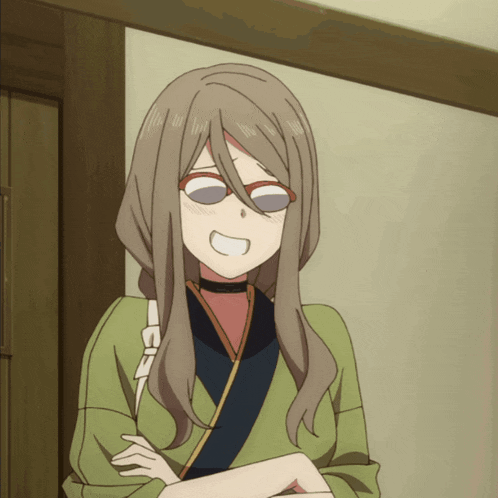 a girl wearing glasses and a choker is smiling