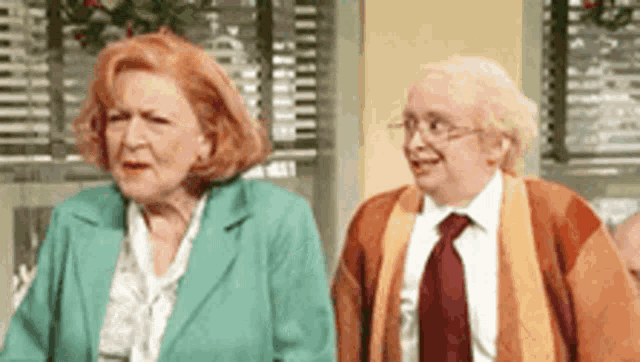 a man and a woman are standing next to each other .