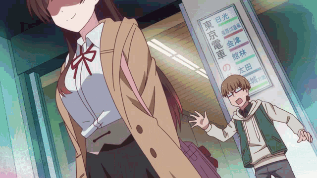 a boy and a girl are standing in front of a sign that says tokyo