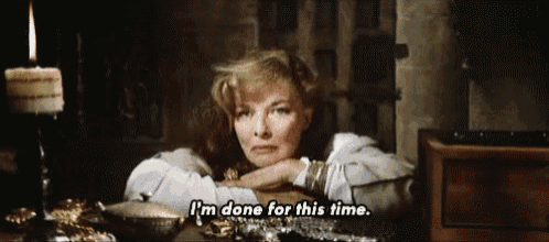 a woman is sitting at a table with a candle in the background and says i 'm done for this time .