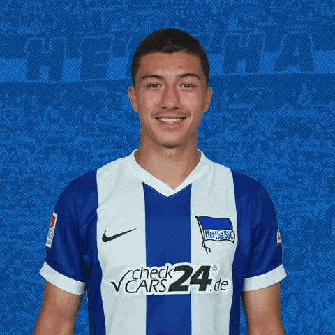 a man wearing a blue and white striped shirt with check24.de on the front