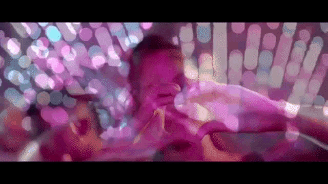 a baby is being held by a woman at a party in a club .