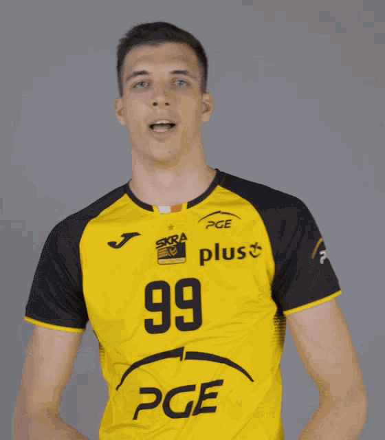 a man wearing a yellow pge plus shirt
