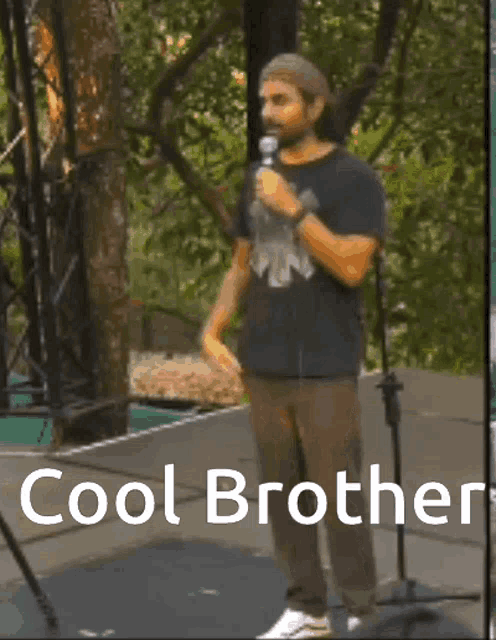 a man with a beard is standing in front of a microphone with the words cool brother below him