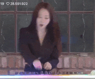a woman in a black jacket is playing a dj set with the number 28591,922 in the corner