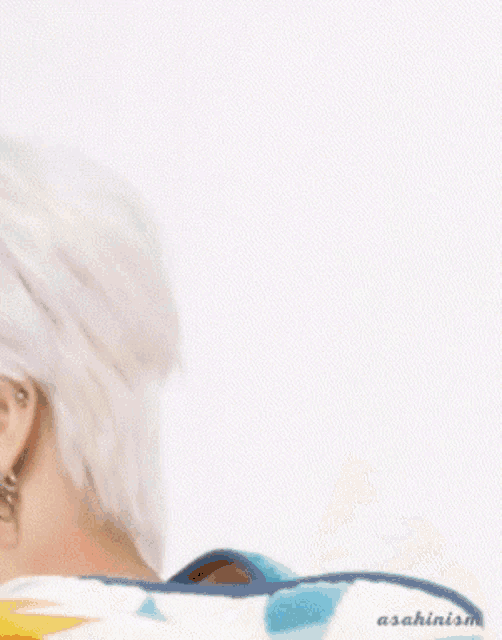 a close up of a person 's face with a white background and a sweater on .