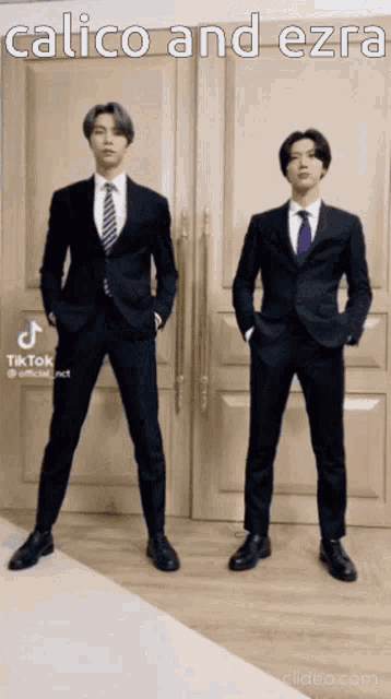 two men in suits and ties are standing next to each other with a caption that says calico and ezra