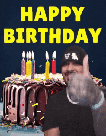 a man giving a thumbs up in front of a birthday cake that says " happy birthday "