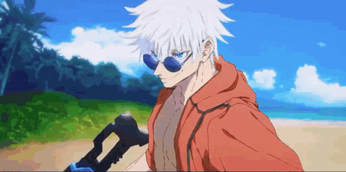 a man wearing sunglasses and a red hoodie is standing on a beach holding a gun .