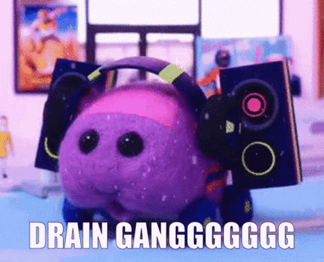 a stuffed animal with headphones and speakers says drain ganggggg