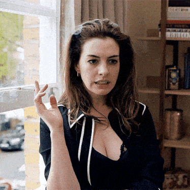 a woman smoking a cigarette next to a window