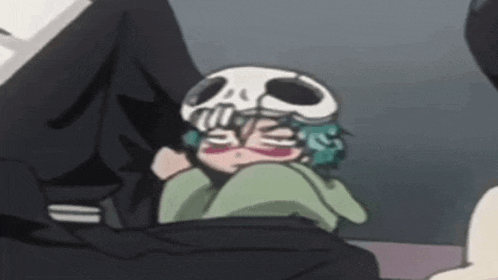 a cartoon character with a skull on his head is sitting next to a person .
