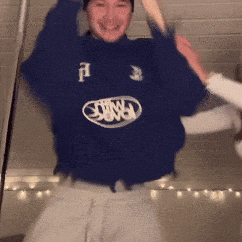 a man wearing a blue sweater with the word ford on the front