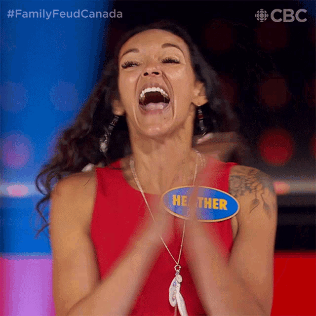 a woman wearing a name tag that says heather is clapping her hands