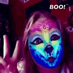a girl with her face painted like a dog and the words boo above her
