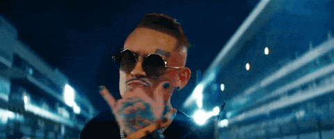 a man with sunglasses and a tattoo on his face