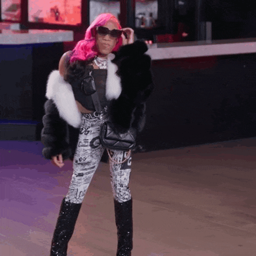 a woman with pink hair is wearing a fur coat