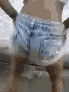 a woman in denim shorts is dancing on a table .