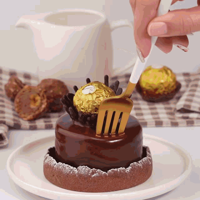 a chocolate cake with a ferrero rocher in the middle