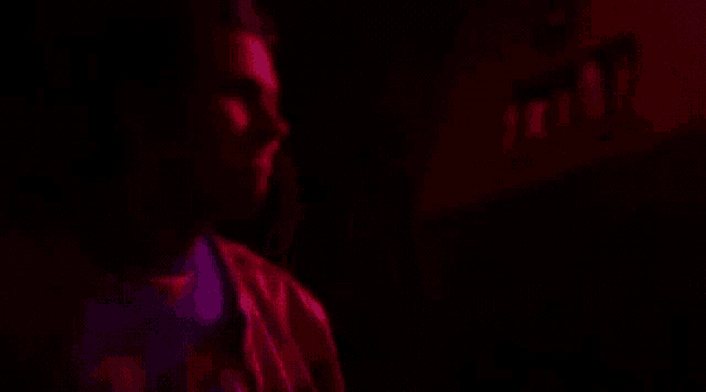 a blurry picture of a man in a purple shirt with the number 8 on it