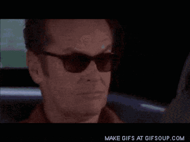 a gif of a man covering his face with his hand and the words make gifs at gifsoup.com