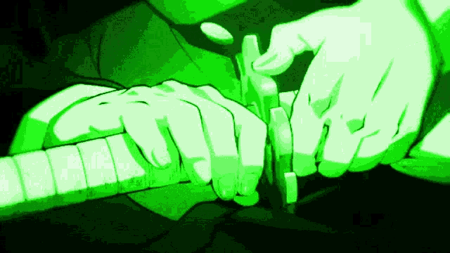 a close up of a person holding a sword in a green light .