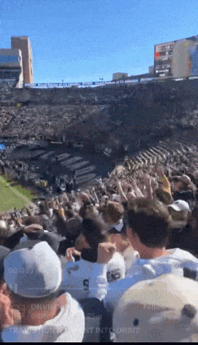 a crowd of people in a stadium with the word orbit on the bottom right