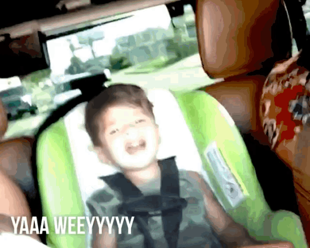 a child is sitting in a car seat with the words yaaa weeyyyy written on the bottom