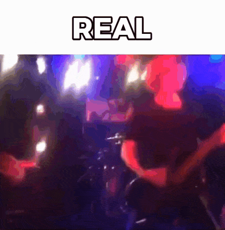 a blurred image of a concert with the word real above it