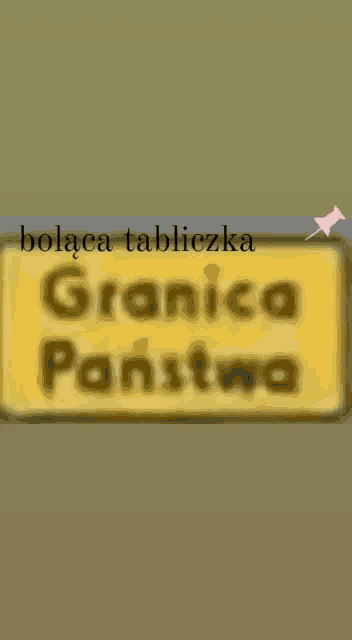 a blurry picture of a yellow sign that says " granica panstwo "